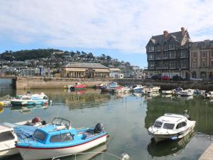 a group of boats are docked in a harbor at The Mew in Dartmouth