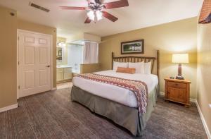 a bedroom with a bed and a ceiling fan at Holiday Inn Club Vacations Fox River Resort at Sheridan in Sheridan