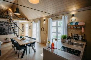 a kitchen and dining room with a table and chairs at Wein Cottage Kellerstöckl in Eisenberg an der Pinka