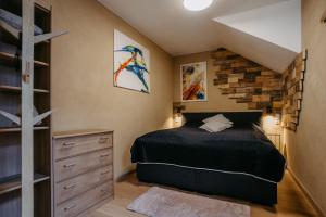 a bedroom with a bed and a brick wall at Wein Cottage Kellerstöckl in Eisenberg an der Pinka