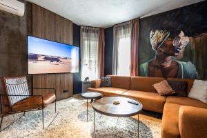 a living room with a couch and a large painting at Bella Roe Premium Apartments in Belgrade