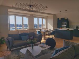 a living room with a couch and a living room and a kitchen at La touline in Concarneau