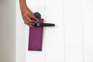 a person is holding a purple door handle at Goldwynn Resort & Residences in Nassau