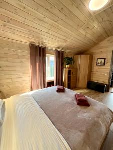 a bedroom with a large bed in a wooden room at Treeskit House in Horenka