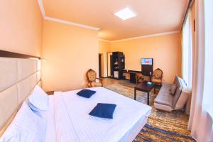 a hotel room with a bed and a living room at Vanadzor Armenia Health Resort & Hotel in Vanadzor