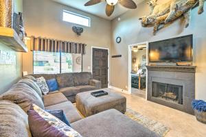 a living room with a couch and a fireplace at Peoria Oasis with Resort Amenities, 2 Mi to Downtown in Peoria