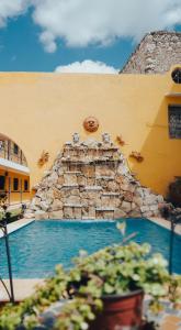 a swimming pool in a resort with a water slide at Hotel Mucuy in Mérida