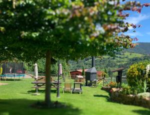a park with a playground with a slide and a picnic table at Apartamentos La Quintana de Romillo in Romillo