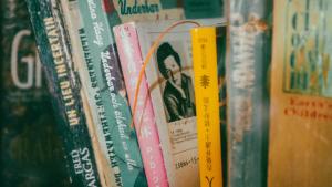 a group of books on a book shelf at Hotel Mucuy in Mérida