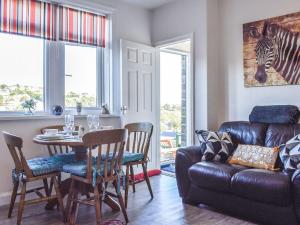 a living room with a table and a couch at Holme Valley Cottage in Holmfirth