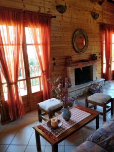 a living room with a table and a fireplace at Xylino Chalet in Kalavrita