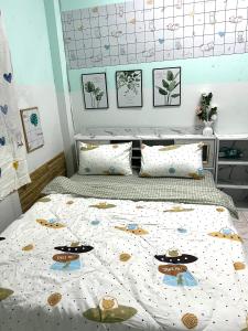 a bedroom with a bed with a hello kitty comforter at Baan Busaya บ้านบุษยา in Ban Khlong Phutsa