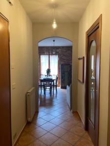 a hallway with a table and a dining room at Casa Luisini in Mondovì