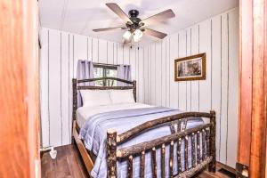 a bedroom with a bed with a ceiling fan at Tranquility Base in Rhinelander