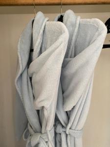 a pile of towels hanging on a towel rack at Pikes Peak Paradise Bed and Breakfast in Woodland Park