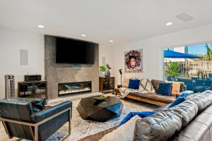 a living room with a couch and a fireplace at Mira Costa Majesty in Oceanside