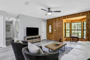 a living room with a couch and a tv at 4636 Whimbrel Lane in Fernandina Beach