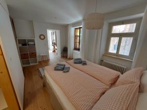 a large bedroom with two beds and two windows at Haus La Punt, Savognin in Rona