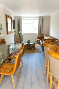 a living room with a glass table and chairs at Lovely 2 bed house in Pitlochry in Pitlochry