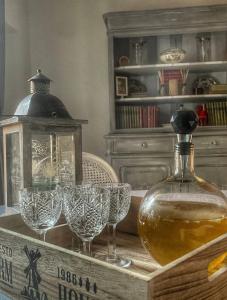 a table with wine glasses and a bottle on it at La dimora del capitano in Genova
