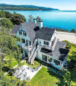 an aerial view of a large house on the water at Auberge La Marmite in La Malbaie