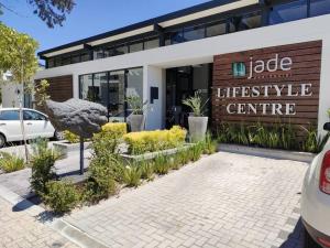 a building with a sign that readseper lifestyle centre at Casa The Jade in Cape Town +1 photo