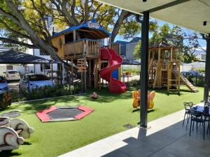 a playground with a tree house and a slide at Casa The Jade in Cape Town