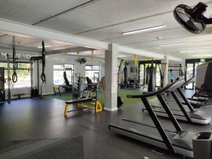 a gym with treadmills and ellipticals in a room at Casa The Jade in Cape Town