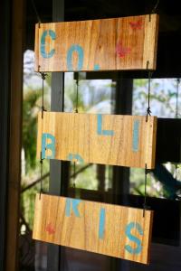 a sign that says go home hanging from a pole at Eden Jungle Lodge in Bocas del Toro