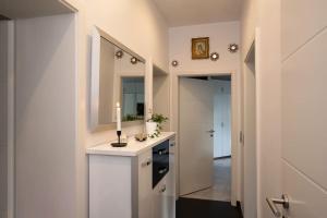 a white kitchen with a candle on a counter at *NEW*Luxus-Wasserbett-SmartTV-Terrasse in Magdeburg