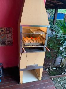 a wooden beehive with hot dogs inside of it at CHALÉS DO GIBA in Maresias