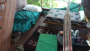 an aerial view of a room with a bed and a couch at treehouse above the beach in Port Antonio