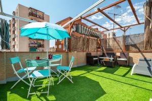 a patio with a table and chairs and an umbrella at Dream House in Badalona
