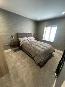 a bedroom with a large bed and a window at Castle St Mews of Southport - 2 bed townhouse in Southport