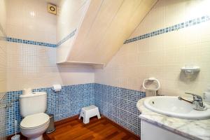 a bathroom with a toilet and a sink at Dream House in Badalona