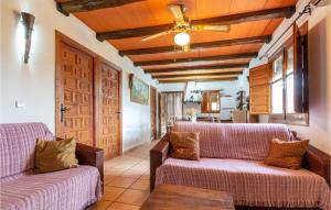 a living room with two couches and a wooden ceiling at 2 Bedroom Nice Home In Antequera in Antequera