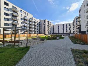 a walkway in front of some apartment buildings at Cozy and modern apartment near Brno city center in Husovice