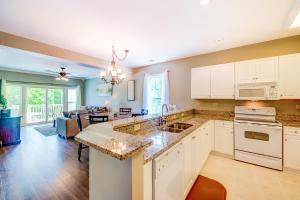 a kitchen with white cabinets and a living room at World Tour 206 in Myrtle Beach