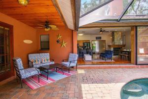a patio with a table and chairs on a house at Family Friendly Pool Paradise Retreat Near Beaches in Palm Harbor