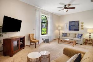 a living room with a couch and a tv at Family Friendly Pool Paradise Retreat Near Beaches in Palm Harbor