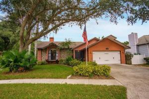 a house with a american flag in front of it at Family Friendly Pool Paradise Retreat Near Beaches in Palm Harbor