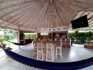 a living room with a large tent with a table and chairs at Hostal Bralgijon Capurganá in Capurganá