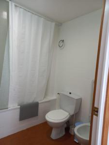 a bathroom with a white toilet and a sink at Morera Pas de la Casa in Pas de la Casa