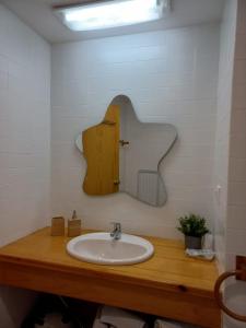 a bathroom with a sink and a mirror at Morera Pas de la Casa in Pas de la Casa