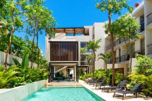 an exterior view of a building with a swimming pool at Chic Studio with Swim-Up Pool Access in Tulum