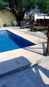 a swimming pool with a picnic table and a playground at Casa "Hielo" Potrero Chico in Hidalgo