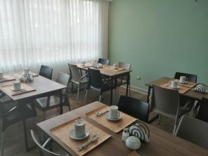 a dining room with wooden tables and chairs at NEREO rooms in Lima