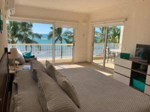 a bedroom with a large bed with a view of the ocean at Condo at Krystal Grand Resort in Bucerías