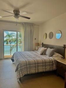 a bedroom with a bed with a ceiling fan at Condo at Krystal Grand Resort in Bucerías