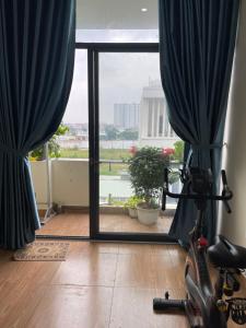 a room with a view of a balcony with blue curtains at 846B50 BÌNH GIÃ in Vung Tau +23 photos